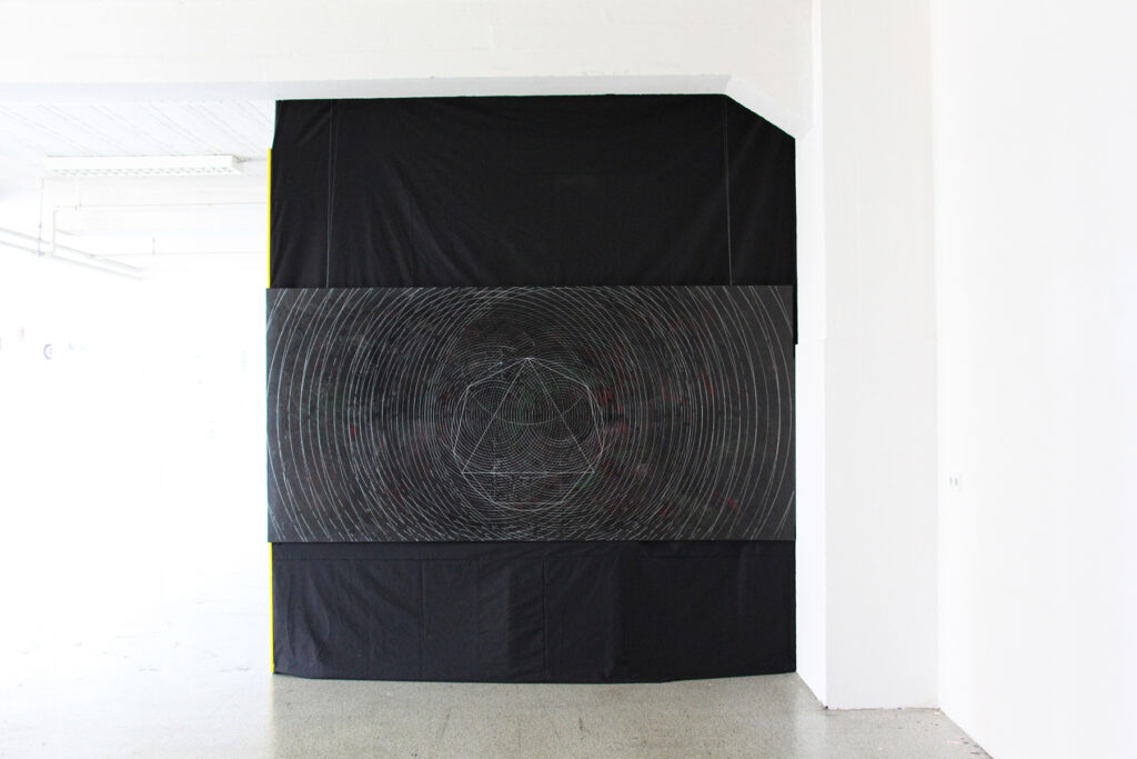 Dark circular painting placed on the floor with white wave-like grid pattern